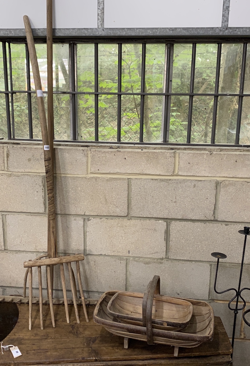 Two traditional trugs, a provincial wood hay fork and a similar rake